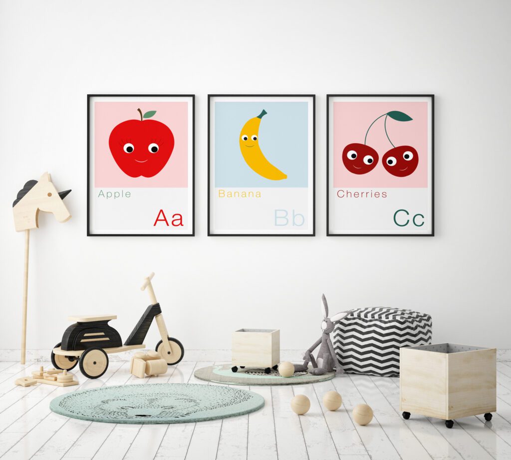 set of 3 alphabet prints A, b, c, on the wall of a nursery featuring an Apple, Banana and Cherries