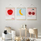 set of 3 alphabet prints A B C featuring an Apple, Banana and Cherries in wooden hanging frames on the wall of the nursery