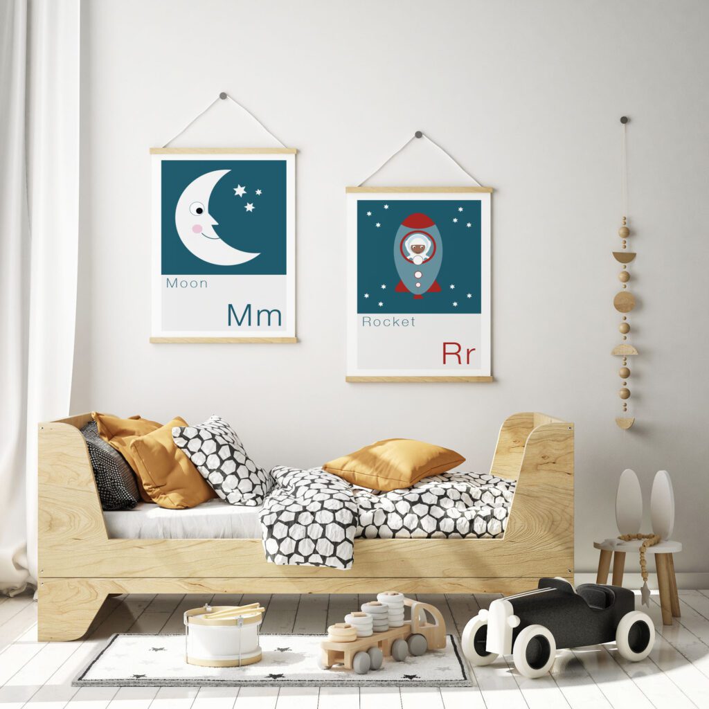 moon and rocket kids prints hung up on wall of bedroom