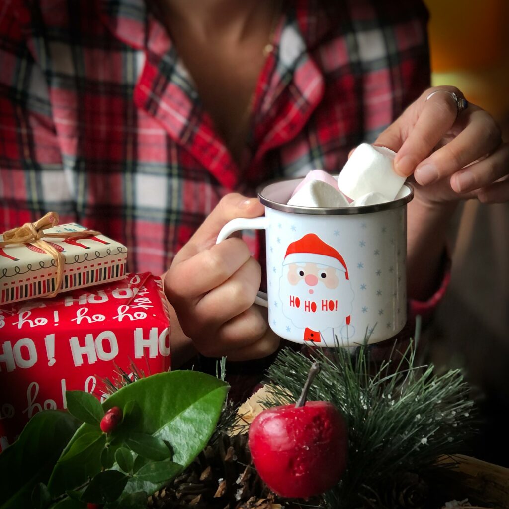 personalised father christmas mug with girl dipping marshmallows in to hot chocolate in her Christmas pyjamas