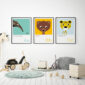 set of three animal alphabet prints on wall of a childs room featuring an anteater, bear and cheetah